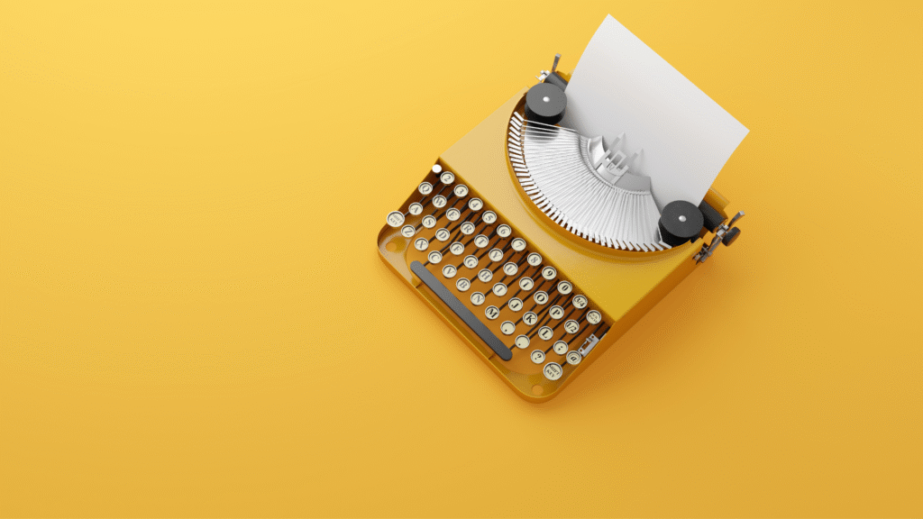 An orange typewriter on an orange background.