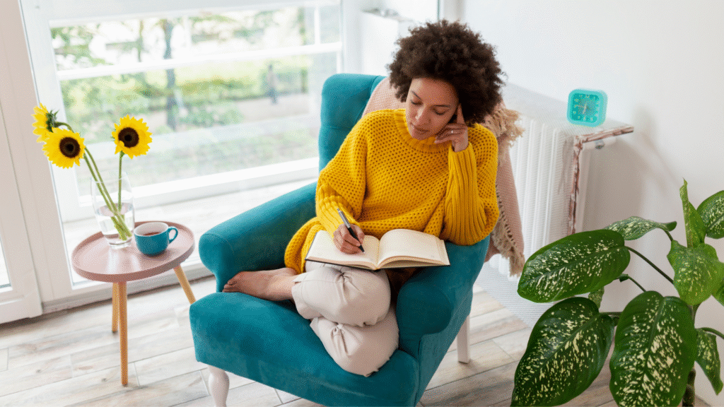 A woman sitting in a chair writing ideas.