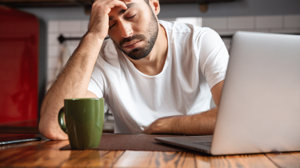 A tired writer with a green coffee mug.